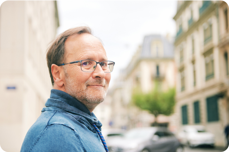 Man with glasses looking at camera